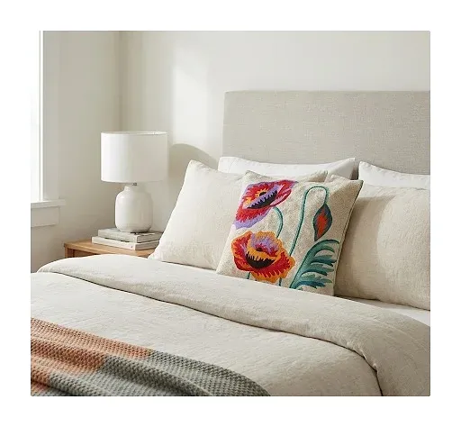 Poppy cushion on a bed